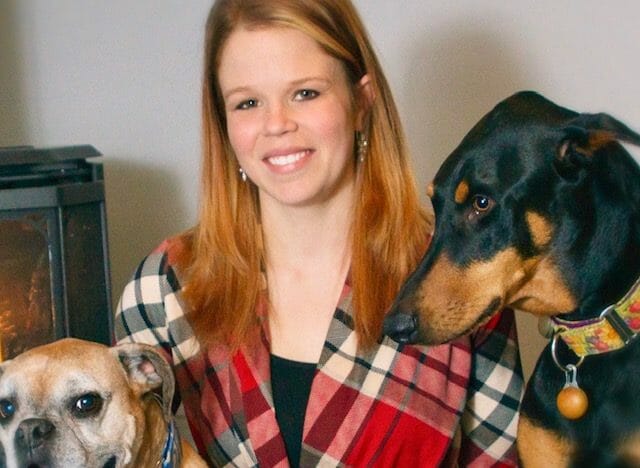 Registered veterinary technician taking a photo with two dogs